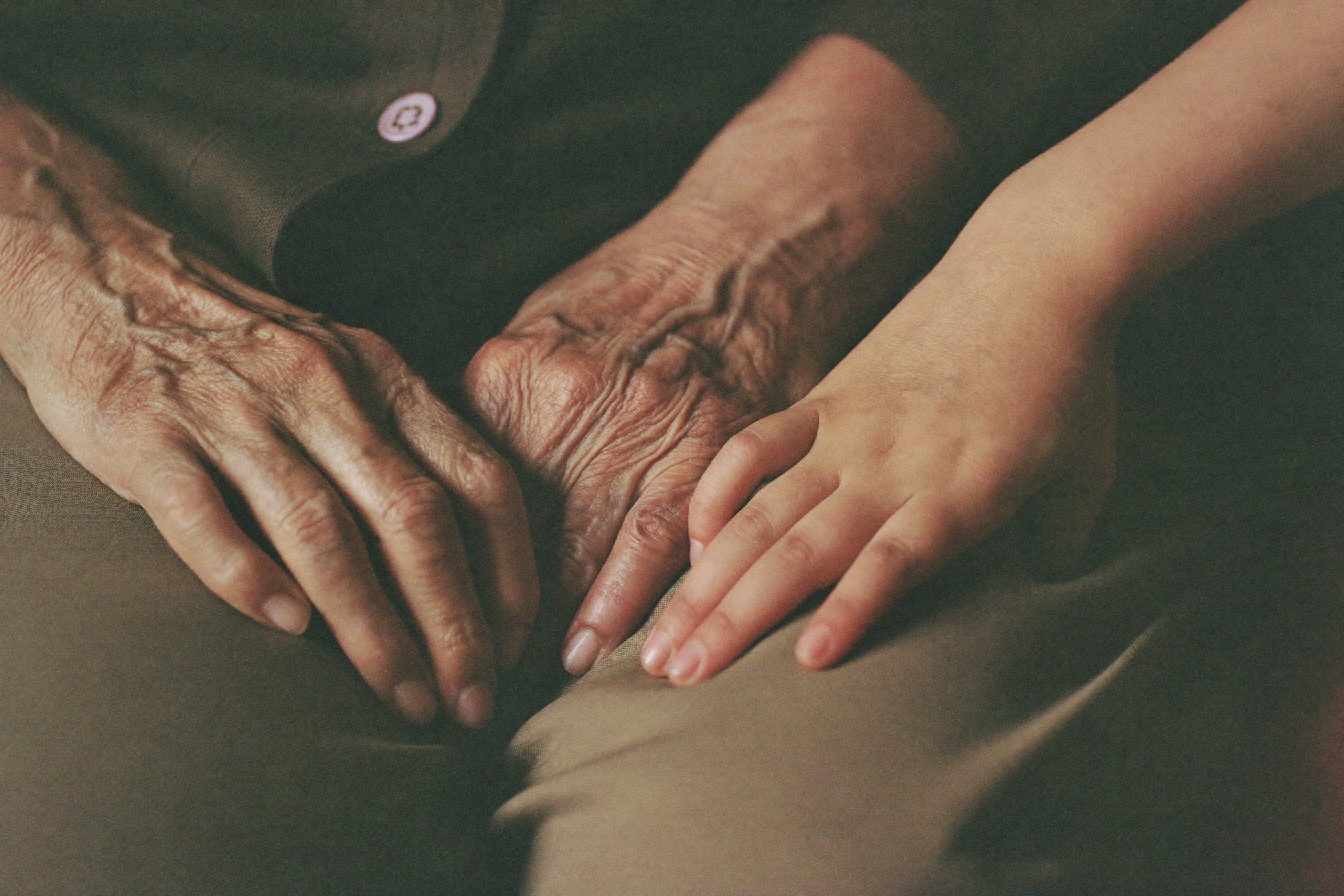 Three generations of hands overlapping