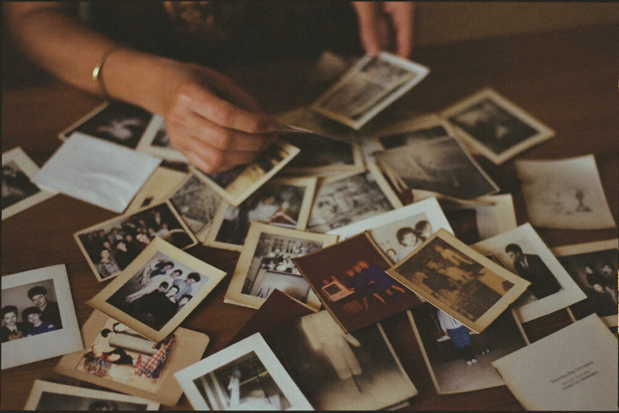 A woman sorting through old family photographs